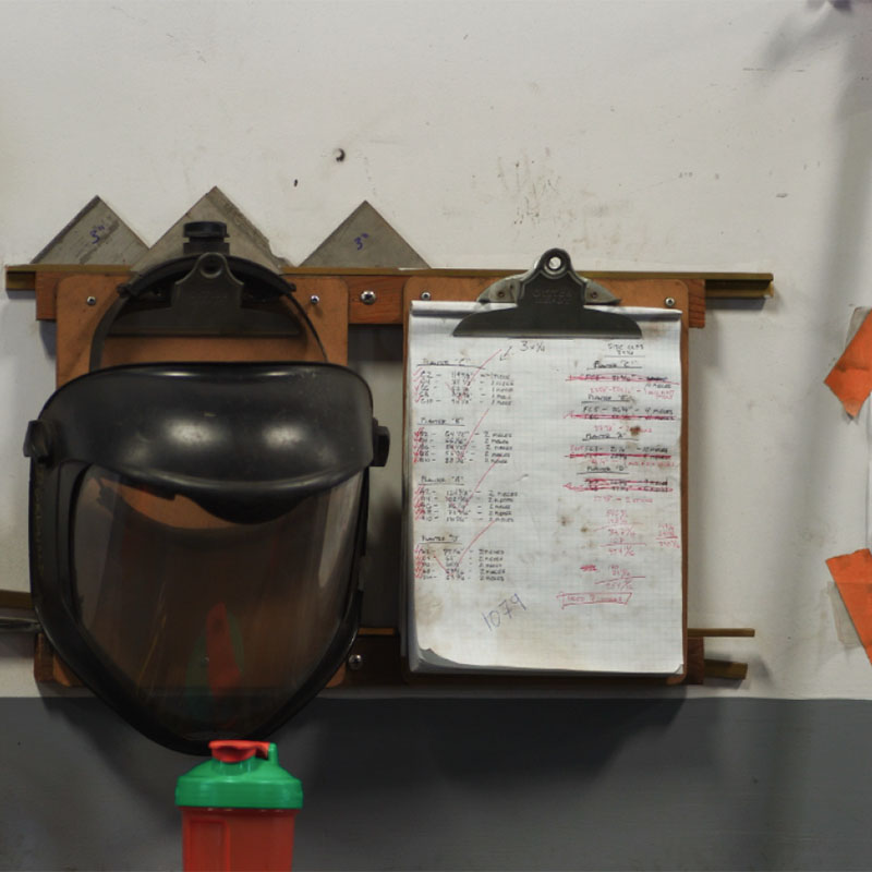 Protective face shield and detailed work checklist at Renfrow+Co, highlighting safety measures in their Houston fabrication facility