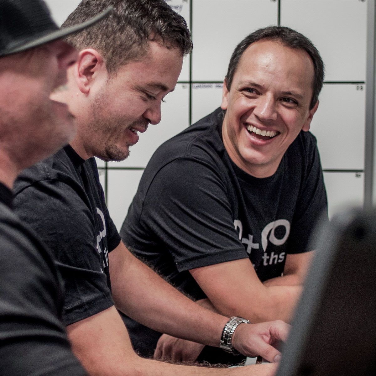 Renfrow+Co’s design team sharing ideas during a meeting highlighting their expertise in custom woodworking and metal fabrication in Houston