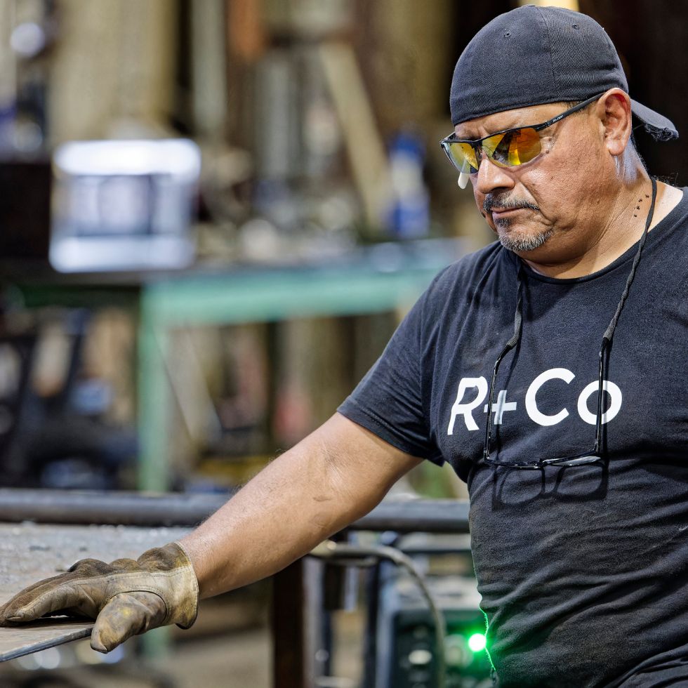 Skilled metalworker at Renfrow+Co handling fabrication processes showcasing expertise in metalworks